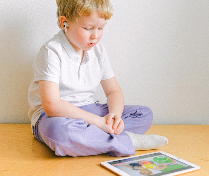 Child using a tablet on the floor